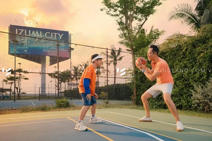 Hai người chơi bóng rổ tại sân thể thao trong khu đô thị Izumi City lúc hoàng hôn